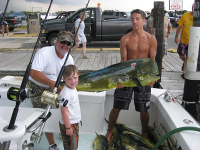 Captain Bo Dobson with son Blake and mate Gene with Blake's 49 pound dolphin caught summer 2010 Outer Banks fishing